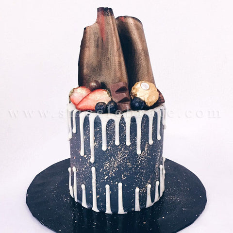Chocolate Coated Cake with Chocolate Drips, Berries, Chocolate Sheets and Ferrero